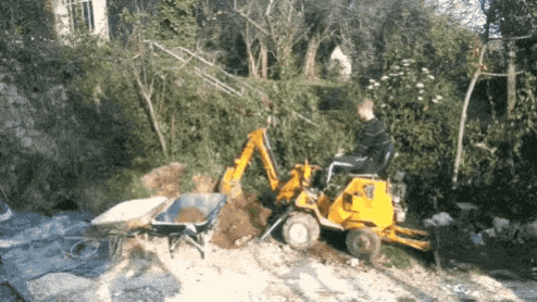 a man is driving a yellow tractor that says ' jcb ' on the front