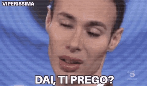 a close up of a man 's face with the words dai , ti prego written on it .