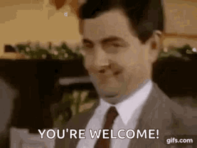 a man in a suit and tie is saying `` you 're welcome '' .
