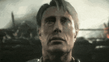 a close up of a man 's face with a serious look on his face