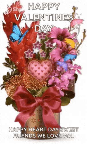 a bouquet of flowers with a heart in the middle of them and a bow .