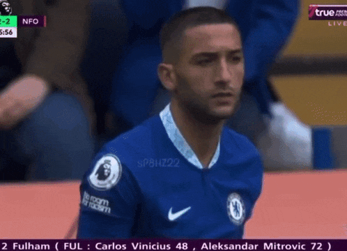 a man in a blue nike jersey is sitting on a field