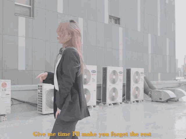 a woman in a suit is standing in front of an lg sign