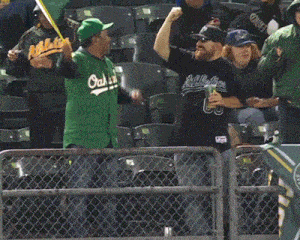 a group of people wearing athletics shirts are holding a green flag