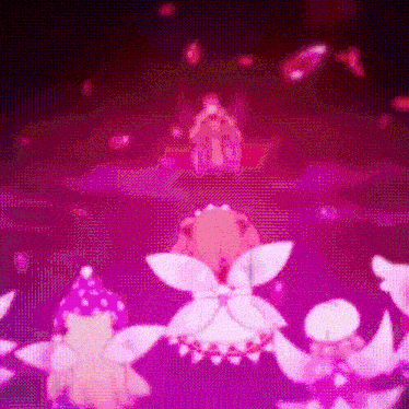 a group of fairy dolls are dancing together in a circle in a dark room .