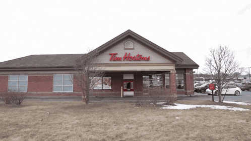 a tim hortons store with cars parked outside