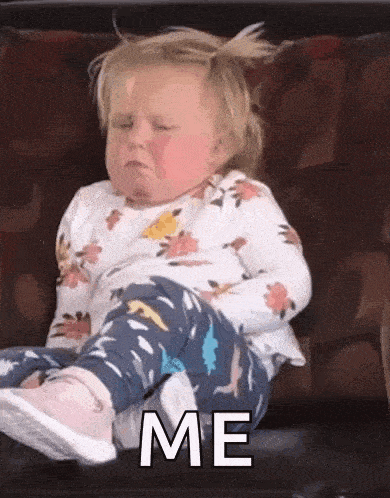 a little girl is sitting on a couch with her eyes closed and the words `` me '' written on her face .