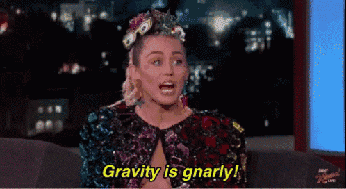 a woman is sitting on a couch and says gravity is gnarly .