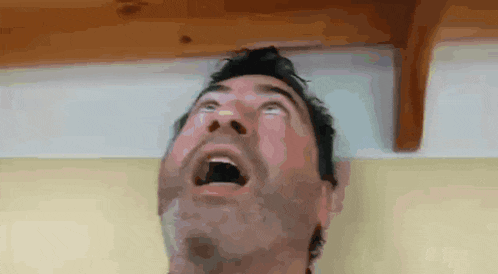a man with his mouth open looking up at the ceiling .