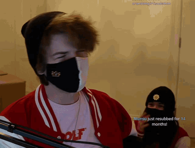 a man wearing a mask and a t-shirt that says wolf on it