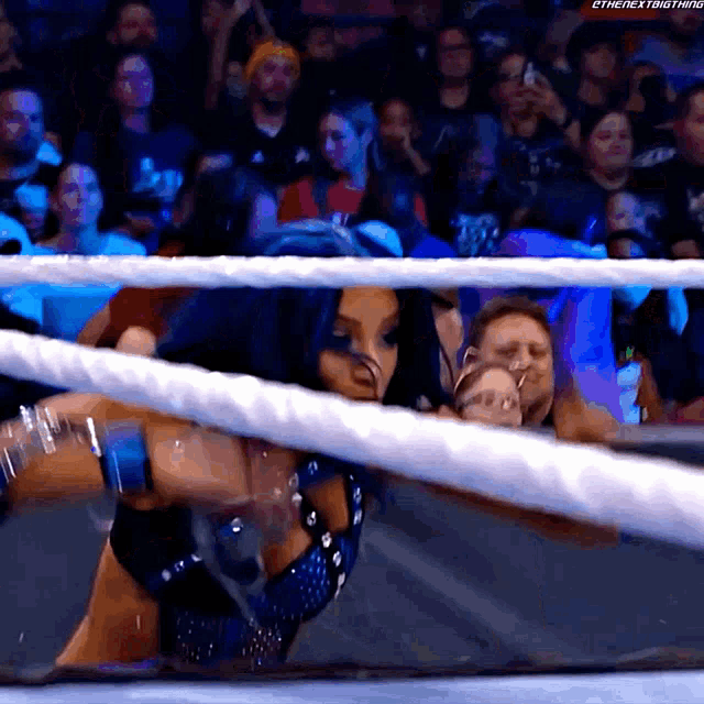 a woman in a wrestling ring with the hashtag #thenextbigthing on the bottom