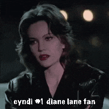 a close up of a woman 's face with the words cyndi # 1 diane lane fan below it