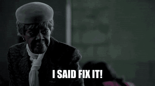 a woman wearing a hat and tie says " i said fix it "