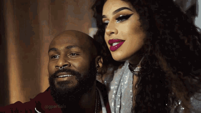 a man with a beard and a woman with red lipstick are posing for a picture with the caption @gpartials