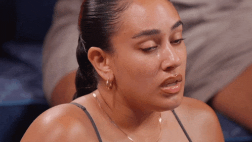 a close up of a woman 's face with tears running down her cheeks