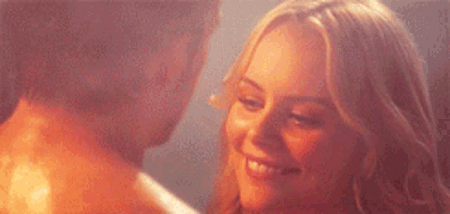 a man and woman are looking into each other 's eyes .