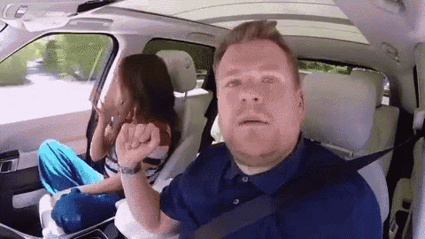 a man and a woman are sitting in a car .