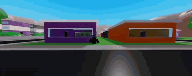 a purple and orange building with a person standing in front of it
