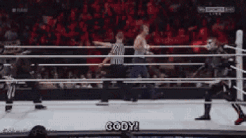 a man in a wrestling ring with the word gody written on the ground