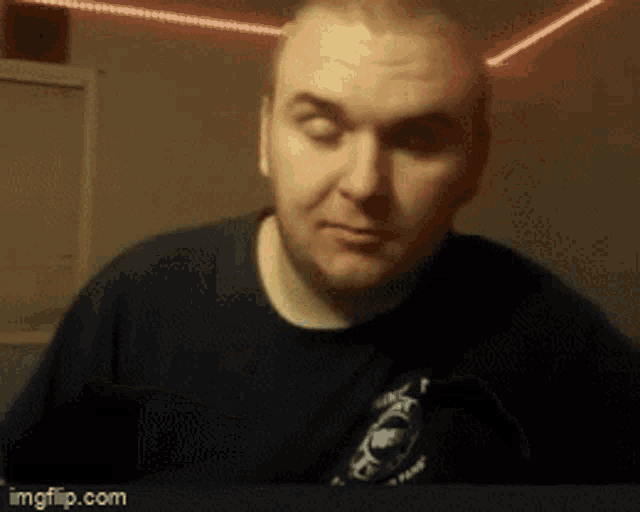a man wearing a black shirt with fox on it