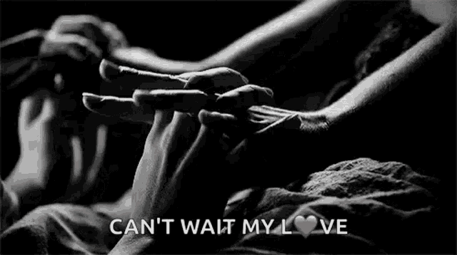 a black and white photo of a couple holding hands with the words `` can 't wait my love '' below them .