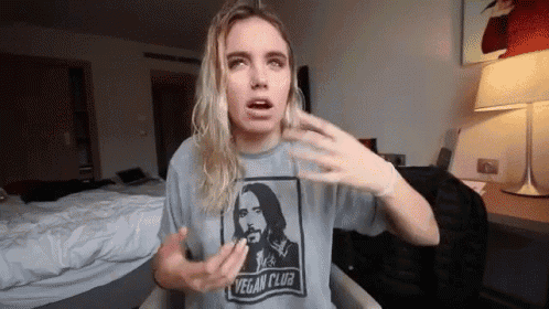 a woman is wearing a t-shirt that says vegan club on it .