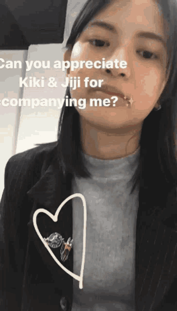 a woman with a heart on her chest is asking if she can appreciate kiki and jiji for companying her