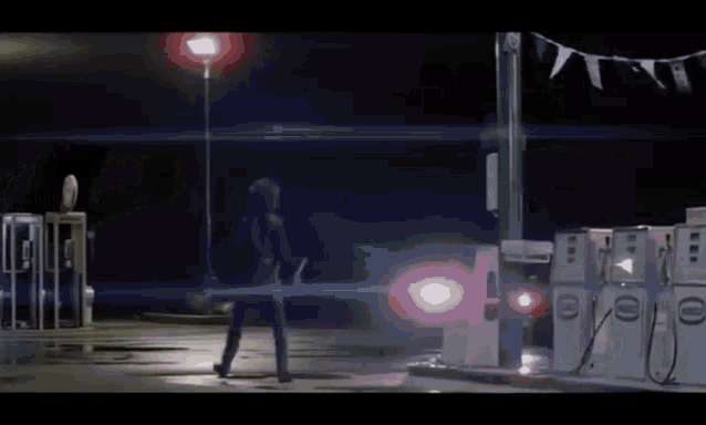 a person is standing in front of a gas pump at a gas station