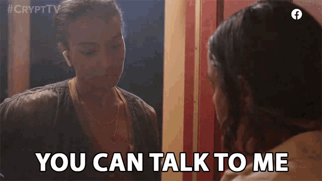 a woman says you can talk to me while looking at herself in a mirror
