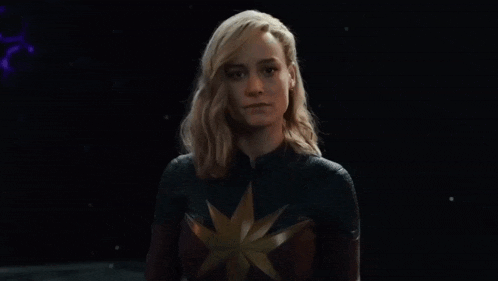 a woman in a superhero costume says wanna fight .