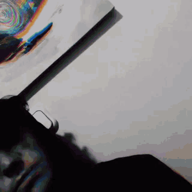 a person is laying on a table with a painting on the wall