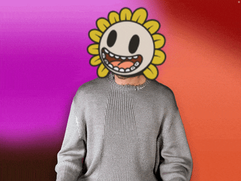 a man in a grey sweater has a smiley face on his face