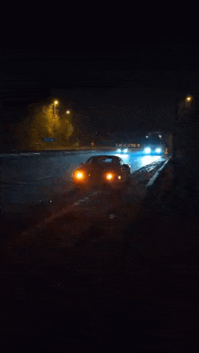 a truck is driving down the road at night