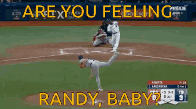 a baseball game is being played with the words " are you feeling randy baby " on the screen