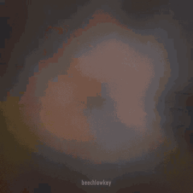 a blurry picture of a woman 's face in a dark room