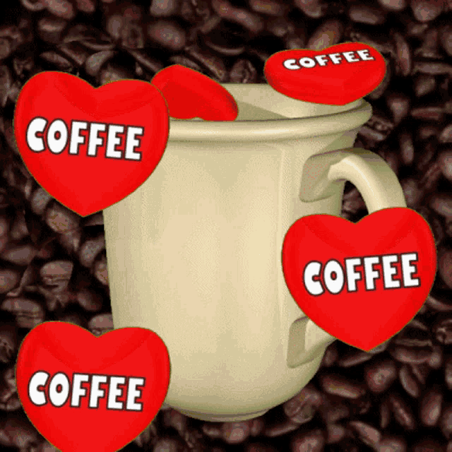 a white cup with red hearts that say coffee