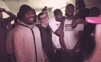 a group of people are posing for a picture in a room .