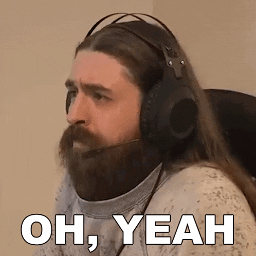 a man with a beard is wearing headphones and says oh yeah .