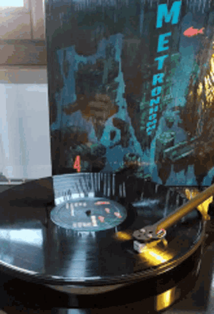 a record player is playing a metronome 4 album