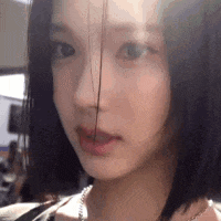 a close up of a woman 's face with a blurred background .