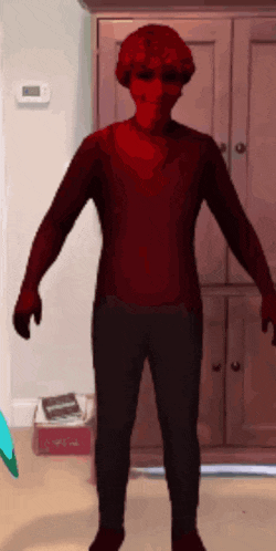 a person in a red sweater and black pants is standing in front of a closet .