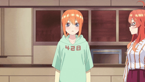 a girl wearing a hoodie that says 428 stands next to another girl