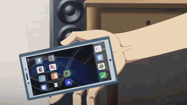 a hand is holding a cell phone with a few apps on it