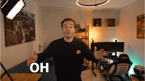 a man wearing an ellesse shirt is standing in a room with the word oh on the bottom