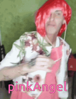 a man wearing a red wig and a pink apron with the word pink angel written on it