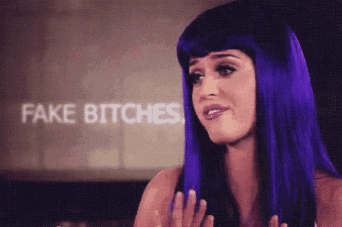 a woman with purple hair is standing in front of a screen that says fake bitches
