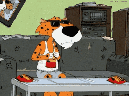 a cartoon cheetah sitting on a couch with a cup of coffee