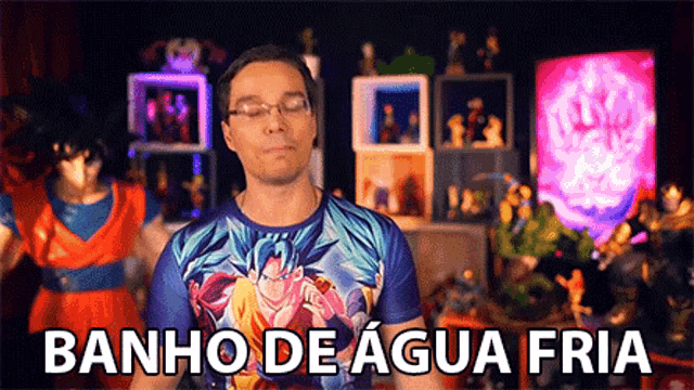 a man wearing a shirt that says banho de agua fria is standing in front of a bunch of action figures .