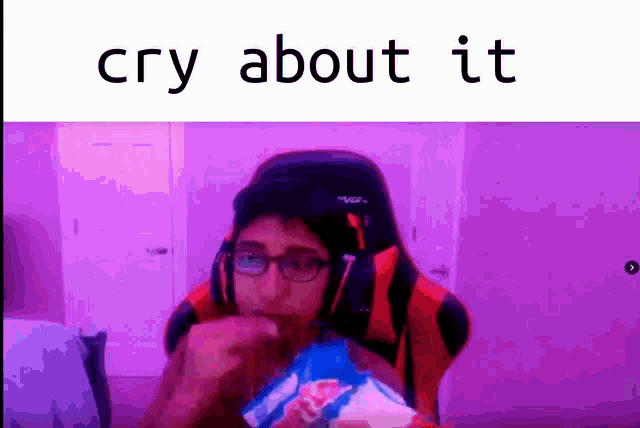 a man in a gaming chair is eating a bag of chips and says `` cry about it '' .