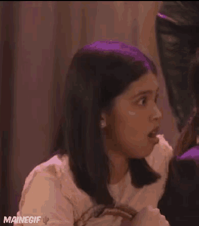 a woman with a surprised look on her face is featured in a mainegif gif